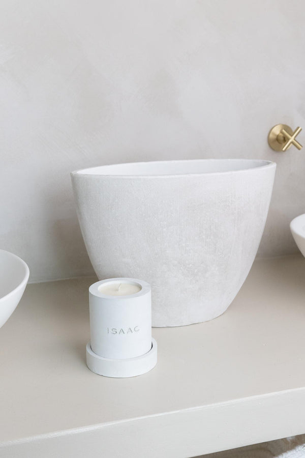 ISAAC 1289: Elements. White SAKYA concrete candle and tray sitting infront of a concrete basin