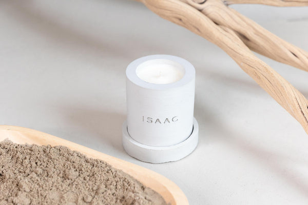 ISAAC 1289 Elements: Grey Concrete Candle and matching tray for DUNE scent, pictured among wood and sand